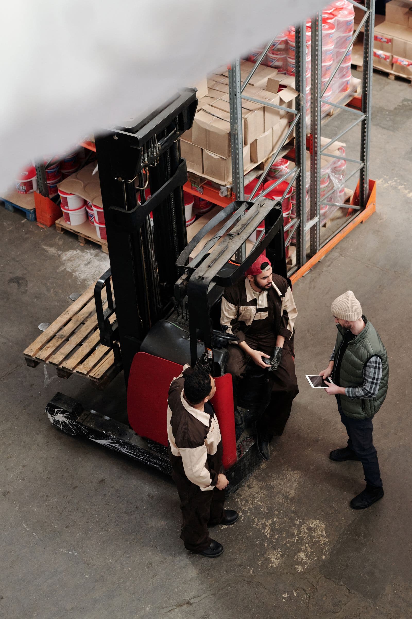 A crew briefing on the warehouse floor during operator training