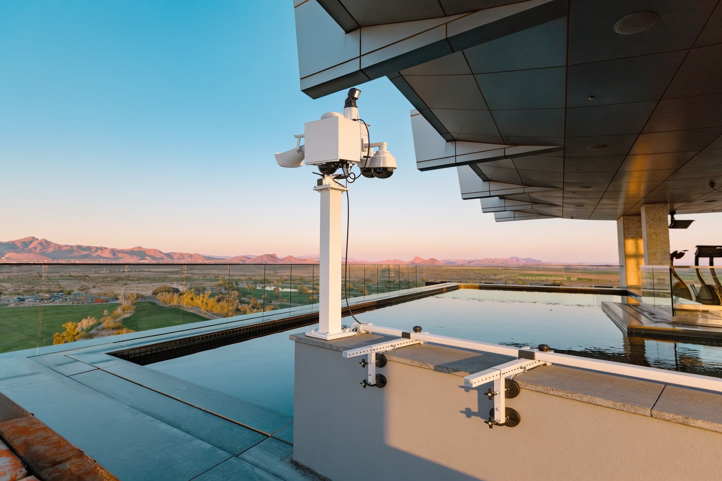 A security camera at the roof corner at blue hour