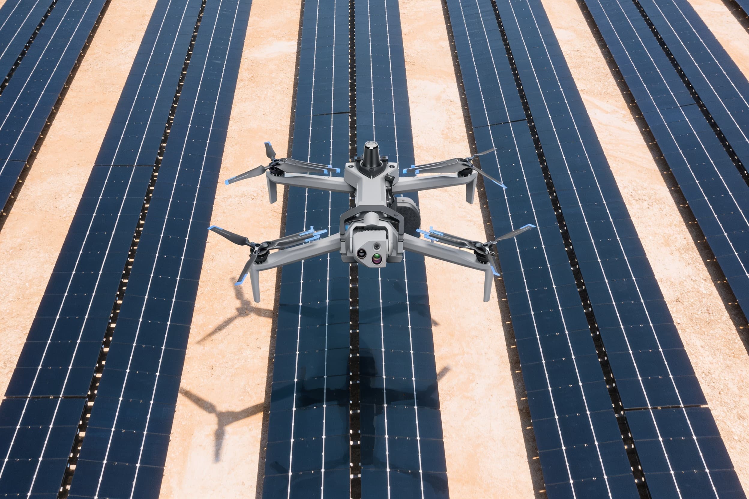 Inspection drone flying over solar-panel rows